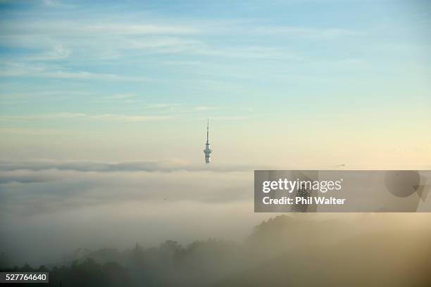 The Auckland Sky Tower struggles to break through a blanket of fog over Auckland City on May 4, 2016 in Auckland, New Zealand. The morning fog...