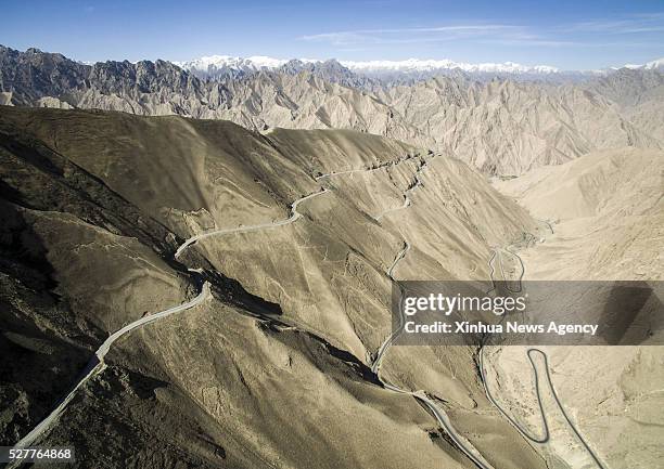 April 30, 2016 -- Photo taken on April 30, 2016 shows the Xinjiang-Tibet Highway passing through mountains in northwest China's Xinjiang Uygur...