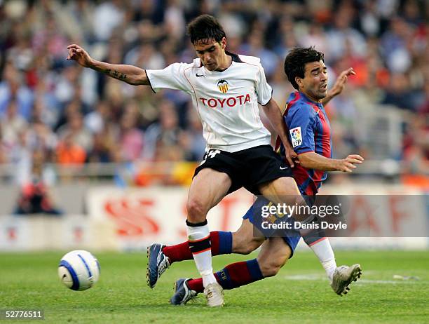 Barcelona's Deco is tackled by Valencia's Vicente Rodriguez during a La Liga match between Valencia and Barcelona at the Mestalla on May 8, 2005. In...