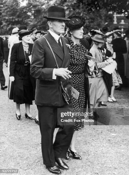 Sir John Henry 'Jock' Delves Broughton, the 11th Baronet of Doddington and Lady Delves Broughton attend the Sandown Park races, 14th July 1939.