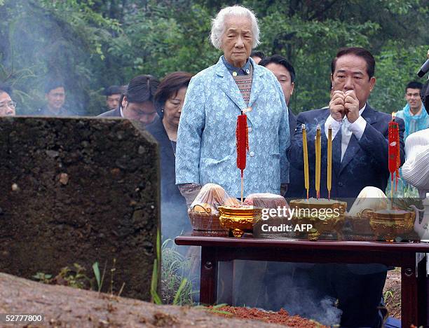 Taiwan opposition politician James Soong , leader of the People First Party, and his mother pay homage to his great-grandfather and grandparents at...