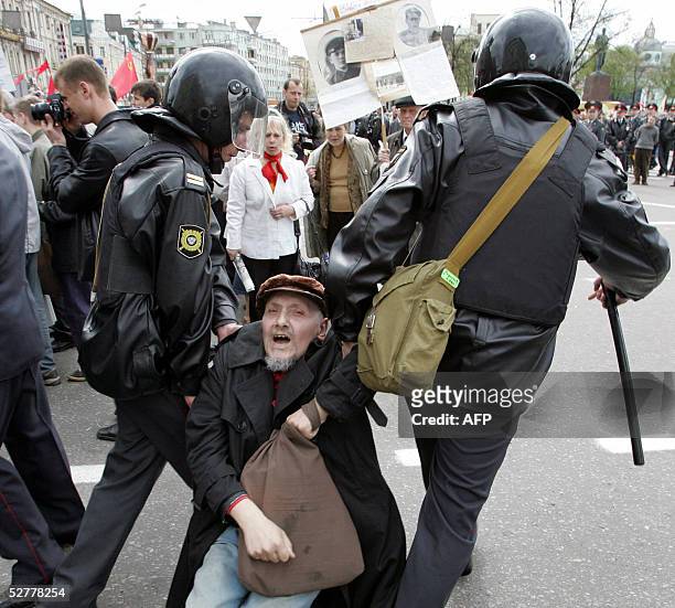 Russian Federation: Russian riot police drag a left-wing activists away during a pro-communist demonstration in the central streets of Moscow, 09 May...