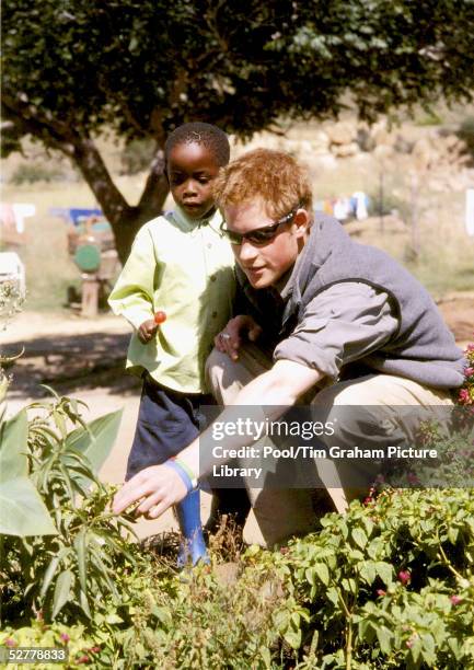 In this undated Clarence House handout photo Prince Harry talks with Mutsu at the Mants-Afe Children's Home, Mohales Hoek. Prince Harry has returned...