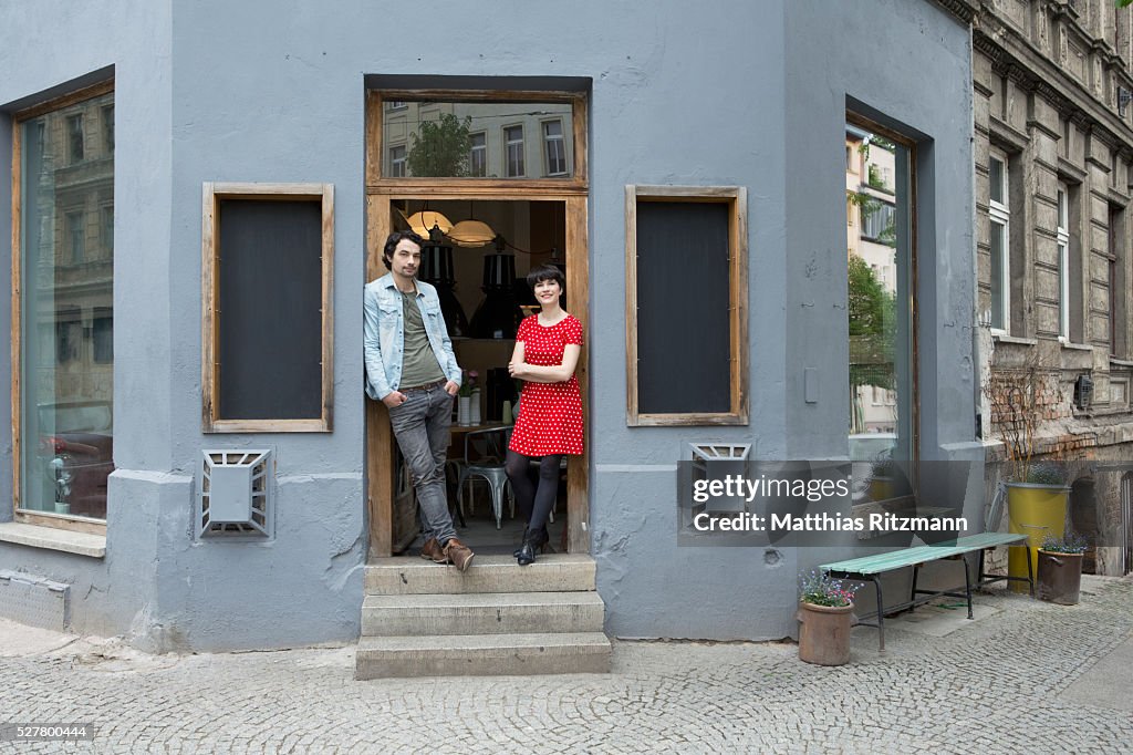 Man and woman standing in front of shop