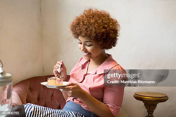 portrait of woman eating cake - black plate stock pictures, royalty-free photos & images