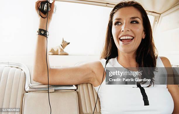 young woman with phone headset in car - bobble head doll stock pictures, royalty-free photos & images