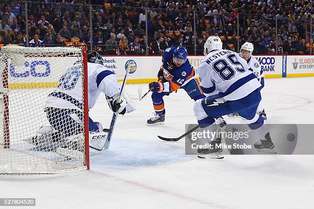 Josh Bailey of the New York Islanders shoots the puck past Ben Bishop of the Tampa Bay Lightning for a first period goal in Game Three of the Eastern...