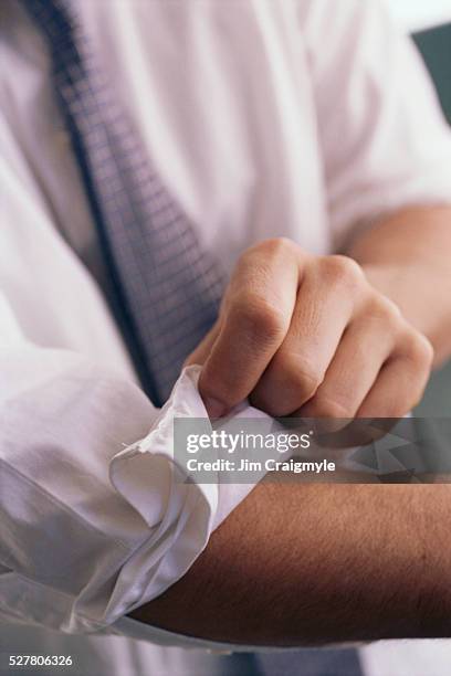 businessman rolling up sleeves - sleeve roll stock pictures, royalty-free photos & images