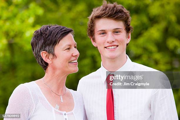 portrait of woman with her son - formal family portrait stock pictures, royalty-free photos & images