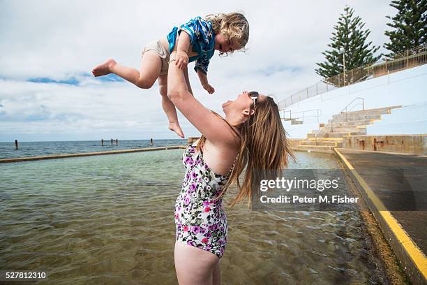 mother with young child (2-3) playing in tidal pool - baby m stock pictures, royalty-free photos & images