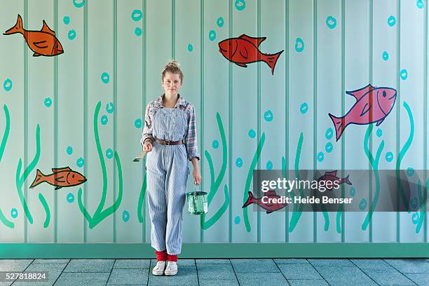 woman with paint of can against mural - painted wall stock pictures, royalty-free photos & images