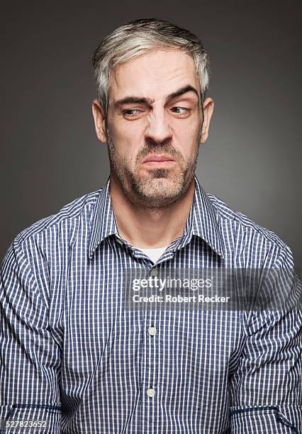 disgusted middle-aged man - afkeer stockfoto's en -beelden
