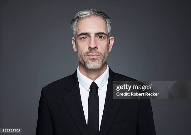 man with graying hair in black suit - formelles portrait stock-fotos und bilder