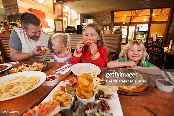 family eating seafood at restaurant - family eating out stock pictures, royalty-free photos & images