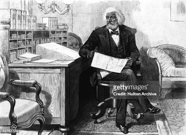 American orator, editor, author, abolitionist and former slave Frederick Douglass edits a journal at his desk, late 1870s.
