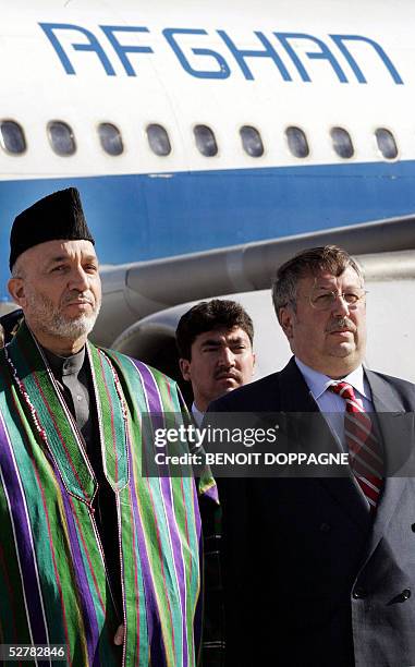Afghan President Hamid Karzai and Belgian Defence Minister Andre Flahaut stand upon Karzai's arrival at Brussels airport 10 May 2005, Karzai pays an...