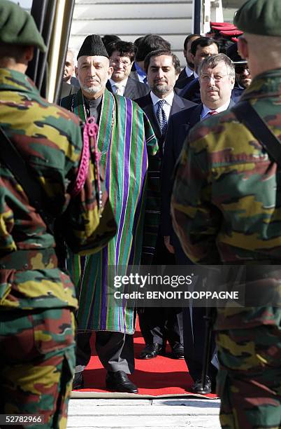 Afghanistan's President Hamid Karzai and his Foreign Minister Abdullah Abdullah arrived in Brussels, are welcomed by Belgian Defence Minister Andre...