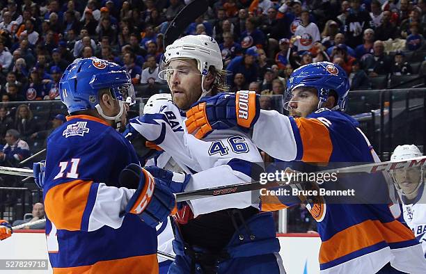 Shane Prince and Steve Bernier of the New York Islanders go up against Michael Blunden of the Tampa Bay Lightning during the second period in Game...
