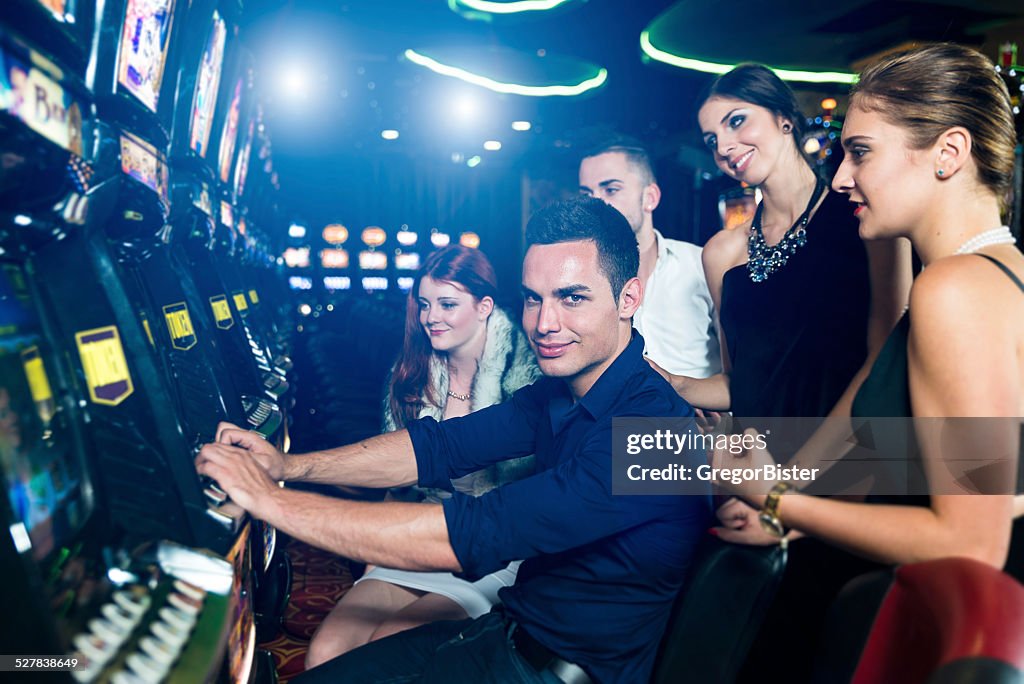 Group of people playing slot machines