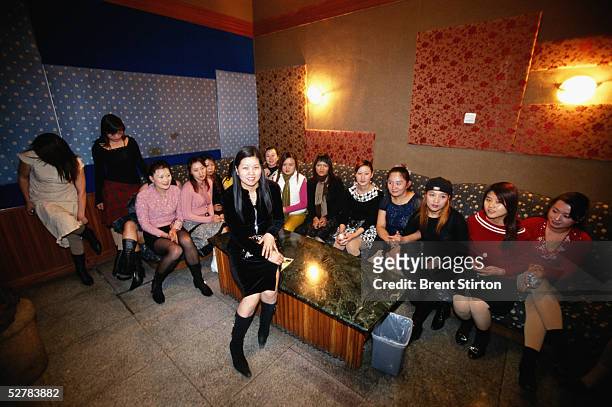 Selection of hostesses sit in a Karaoke bar November 19, 2004 on the outskirts of Beijing. The women are brought into the room when clients arrive...
