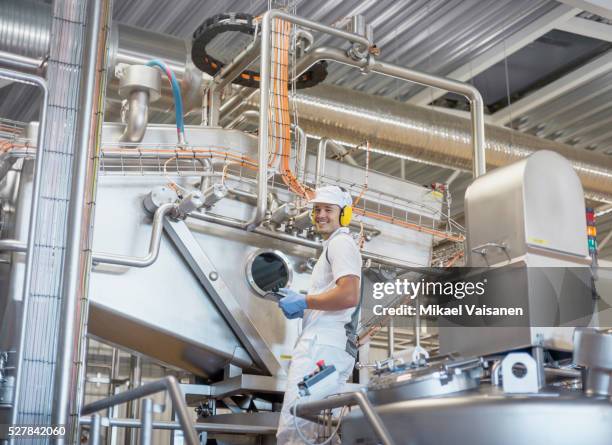 skilled worker at food production line in cheese factory - dairy products stock pictures, royalty-free photos & images