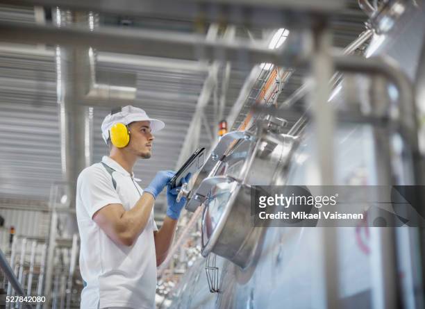 skilled worker at food production line in cheese factory - food and drink industry stock pictures, royalty-free photos & images