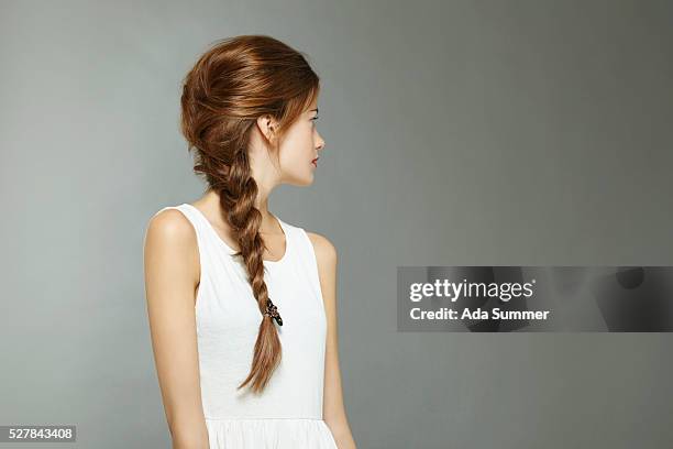 studio portrait of young woman in white tanktop - braid hairstyle stock pictures, royalty-free photos & images