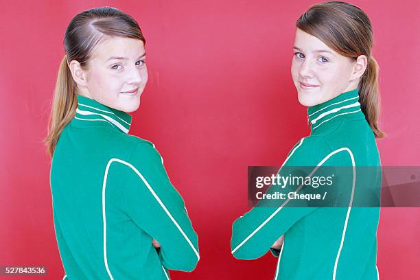 sisters wearing green jackets - female twins stock pictures, royalty-free photos & images