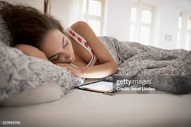 woman sleeping in bed - oversleep stock pictures, royalty-free photos & images