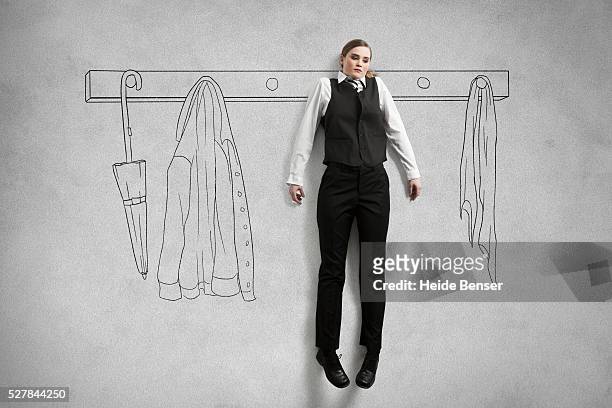 business woman hanging on wardrobe - coat hanging stock pictures, royalty-free photos & images