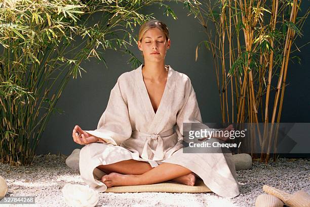 woman meditating - woman in bathrobe stock pictures, royalty-free photos & images