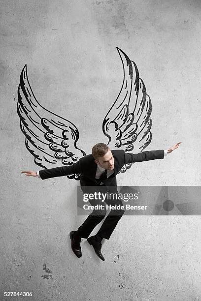 business man flying with big wings - man angel wings stock pictures, royalty-free photos & images
