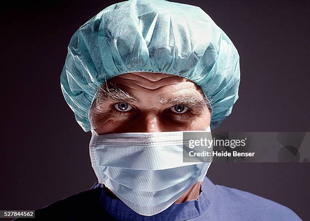 portrait of a evil-looking surgeon - corrupção imagens e fotografias de stock