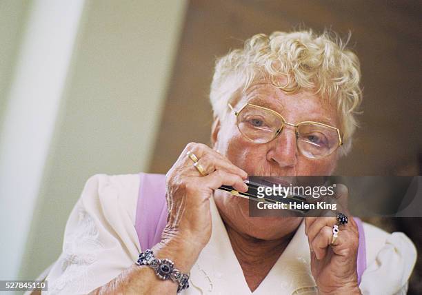 senior woman playing harmonica - harmonica stock pictures, royalty-free photos & images