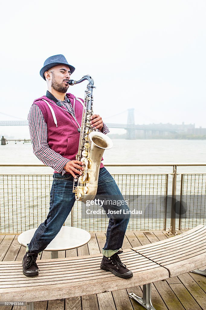 Mid-adult man playing saxophone