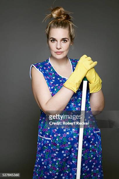 studio shot of cleaning woman - stereotypical housewife stock-fotos und bilder