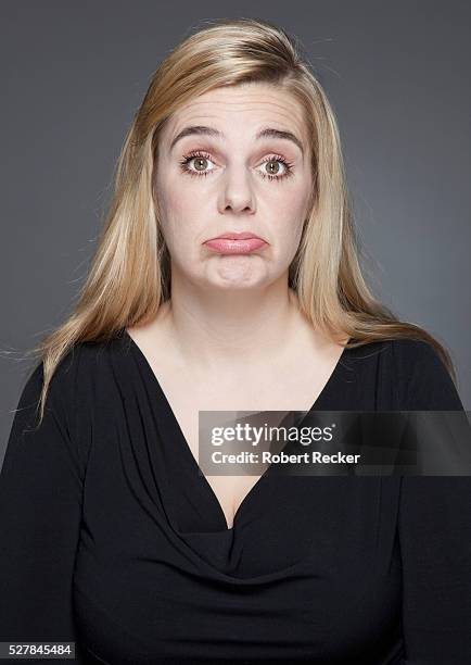 studio shot of blond haired woman making face - vintage funny black and white stock-fotos und bilder