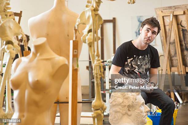 male student studying mannequins in studio - male likeness stock pictures, royalty-free photos & images