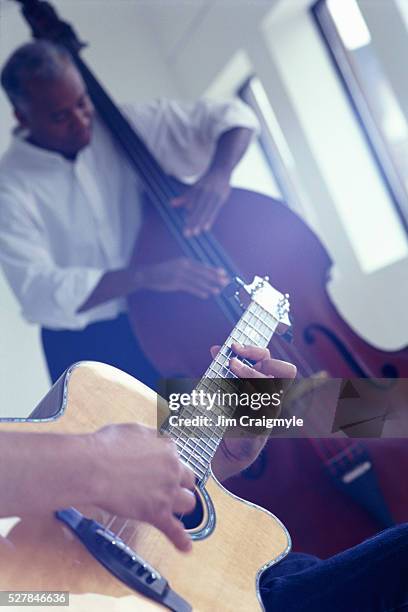 playing acoustic guitar and double bass - jim craigmyle guitar stock pictures, royalty-free photos & images