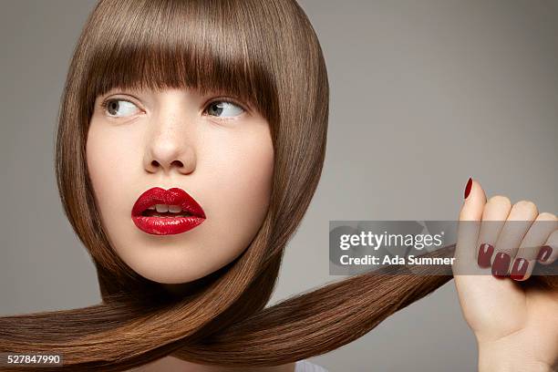 woman pulling hair - shiny straight hair stock pictures, royalty-free photos & images