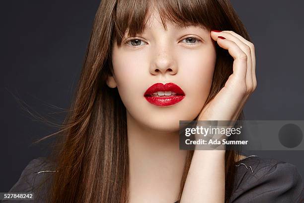 pensive young woman - red lips stock pictures, royalty-free photos & images