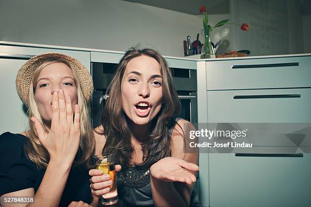 two young women sending kisses towards camera - cocktail party home stock pictures, royalty-free photos & images