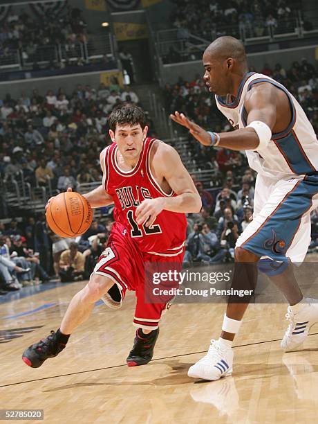 Kirk Hinrich of the Chicago Bulls moves the ball against Antawn Jamison of the Washington Wizards in Game three of the Eastern Conference...