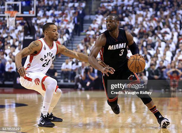 Dwyane Wade of the Miami Heat dribbles the ball as Norman Powell of the Toronto Raptors defends in the first half of Game One of the Eastern...