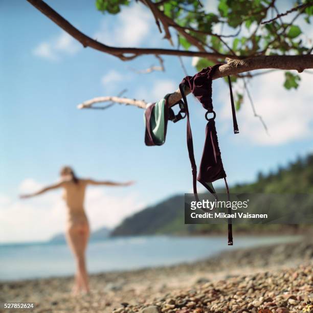 woman on beach - women skinny dipping stockfoto's en -beelden