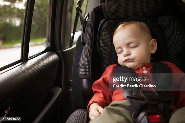 sleeping baby in car seat - baby car seat stock pictures, royalty-free photos & images