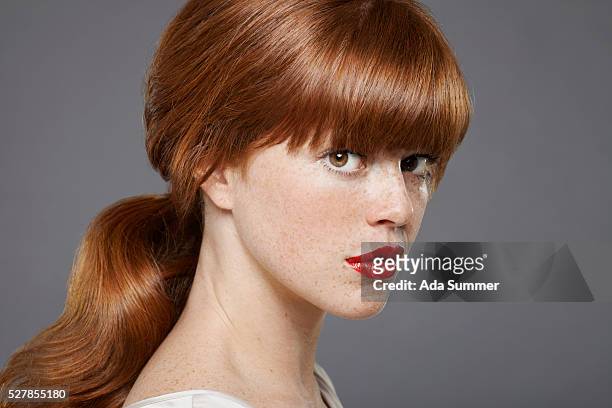 studio portrait of young woman wearing lipstick - bangs ストックフォトと画像