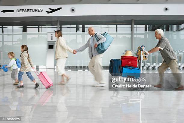 passengers and travelers in airport - luggage trolley stock pictures, royalty-free photos & images