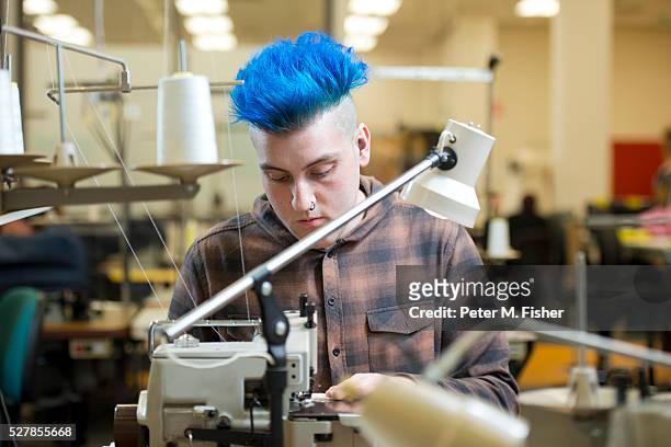 a fashion designer working on a sewing machine - blue hair stock pictures, royalty-free photos & images