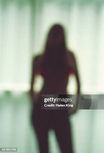 blurred silhouette of young woman - woman in silhouette stock pictures, royalty-free photos & images